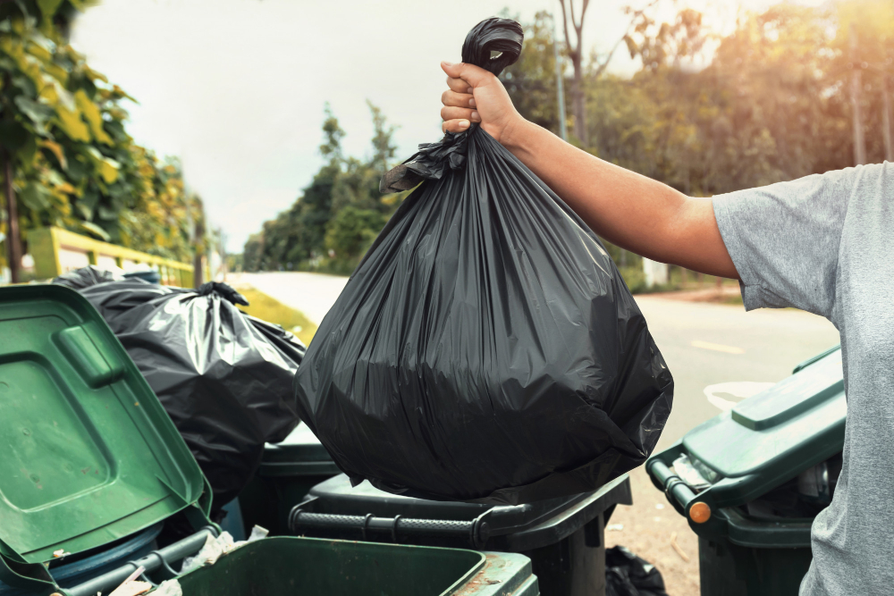 woman hand holding garbage black bag cleaning trash